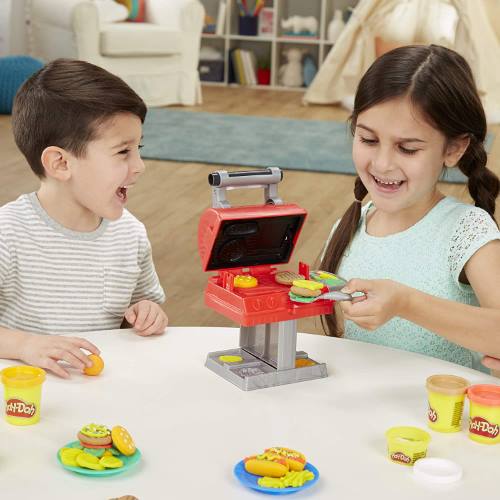 Children playing with Play-Doh Kitchen Creations Grill N Stamp Playset