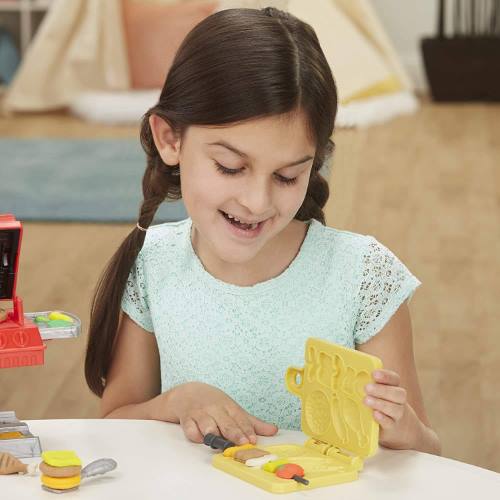 Children playing with Play-Doh Kitchen Creations Grill N Stamp Playset